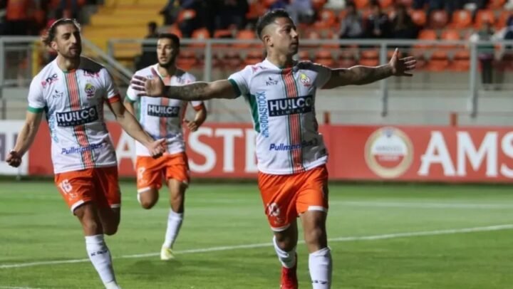a group of men in sports uniforms on a field